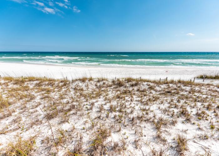 White sand dunes and turquoise Gulf water at Miramar Beach