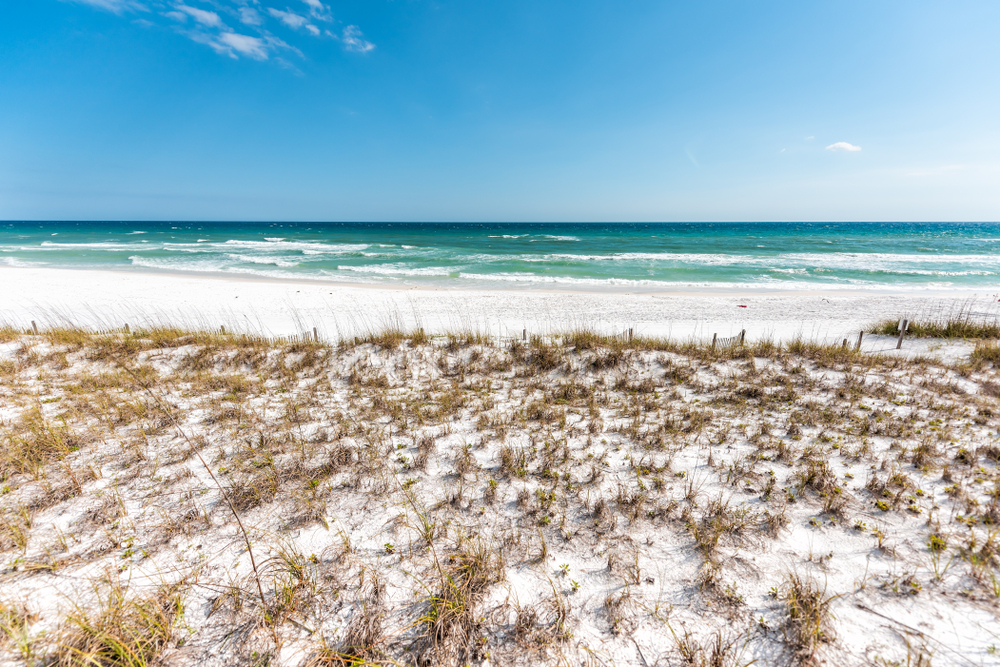 White sand dunes and turquoise Gulf water at Miramar Beach