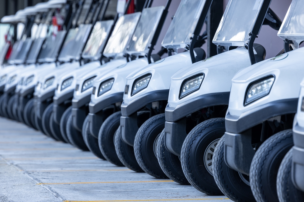 Row of golf carts parked side by side